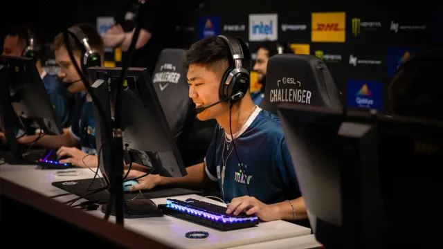 Insani, a CS2 player for MIBR, sits at his PC smiling at ESL Challenger Melbourne.