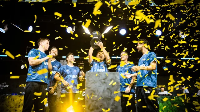 The MIBR squad hoist the trophy at ESL Challenger Melbourne 2024 as confetti falls.
