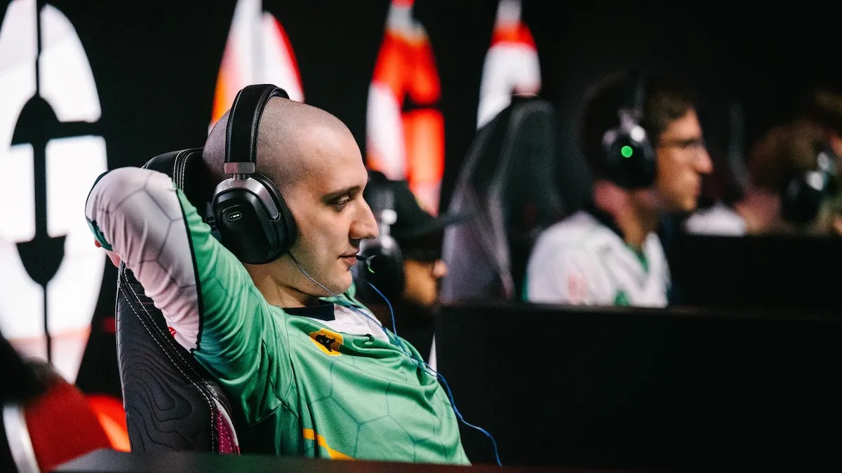 Arteezy sits back in his chair with his arms crossed behind his head.