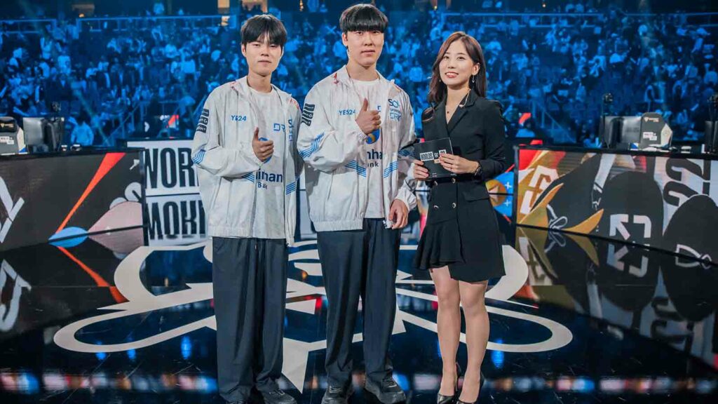 Kim "Deft" Hyuk-kyu and Kim "Zeka" Geon-woo of DRX pose with Jeesun Park after their victory against Gen.G at the League of Legends World Championship Semifinals on October 30, 2022 in Atlanta, GA